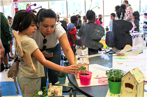 woman and child examining plant